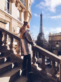 Woman standing in a city, paris, eiffel tower 