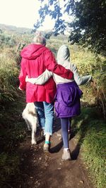 Rear view of girl walking on road