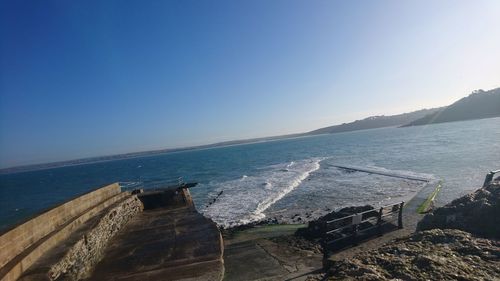 Scenic view of sea against clear blue sky