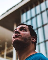 Close-up of man in front of built structure