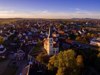 High angle view of houses in town against sky