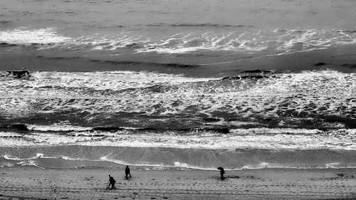 People on beach by sea