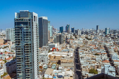 High angle view of buildings against blue sky