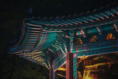 Low angle view of illuminated building at temple