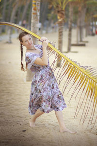 Full length of woman standing at beach