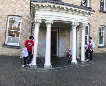 Full length of people standing against building