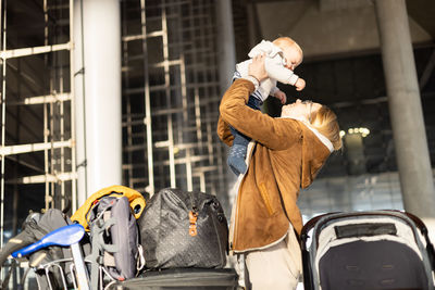 Rear view of man with backpack while standing in city