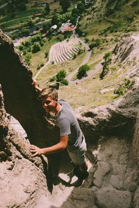 Side view of man on rock