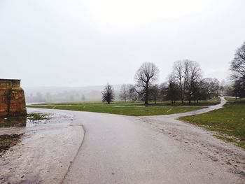Road by landscape against clear sky