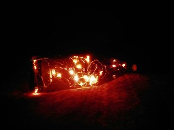 Close-up of illuminated fire in the dark