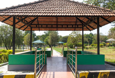 Empty chairs and table in park