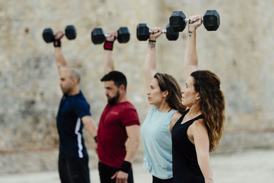 Athletes lifting a crossfit weights in an urban enviroment.