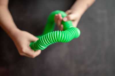 Anti stress sensory pop tube toys in a children's hands. a little kids plays with a poptube toy