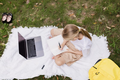 High angle view of woman sitting on field