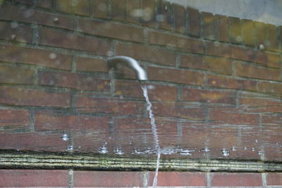 Close-up of water drops on brick wall