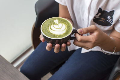 Woman holding coffee cup