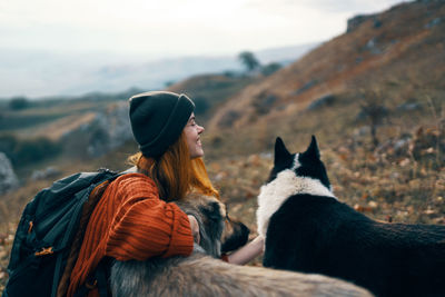 Man sitting with horse in background