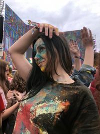 Smiling young woman enjoying at holi