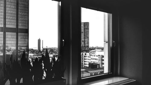 People in city buildings seen through glass window