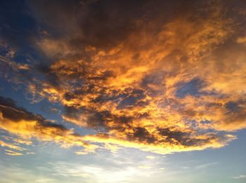 Low angle view of cloudy sky at sunset