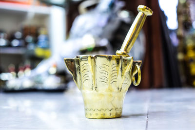 Close-up of antique mortar and pestle on table