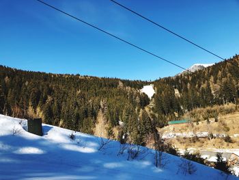 Scenic view of snowcapped mountains against blue sky