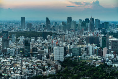 High angle view of modern buildings in city against sky