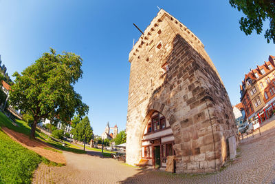 Low angle view of buildings against clear blue sky