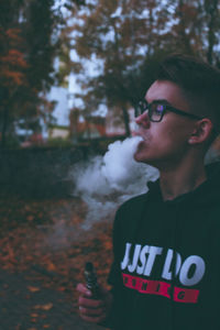 Young man smoking on table