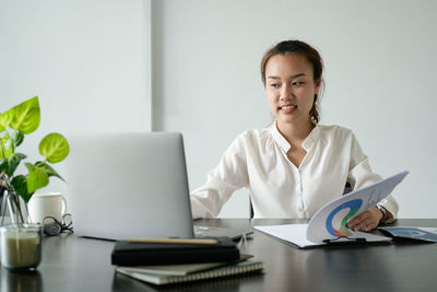 Portrait of businesswoman working at desk in office