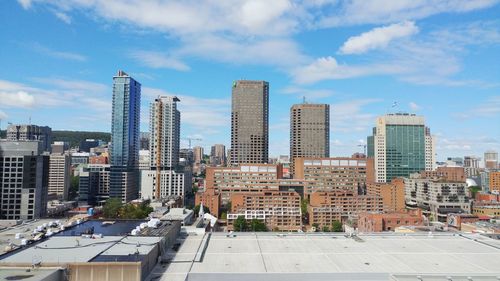 View of skyscrapers against cloudy sky