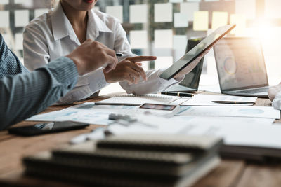 Midsection of business colleagues working in office