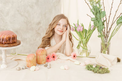 Smiling girl looking away while sitting at home