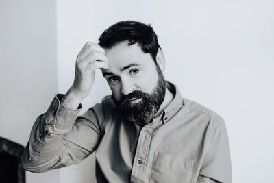 Portrait of smiling man standing against white background