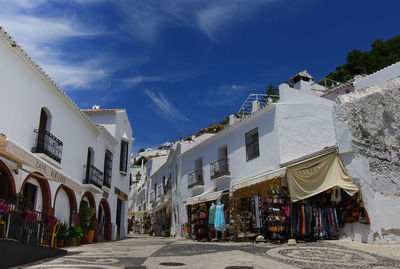 Street amidst buildings in city against sky