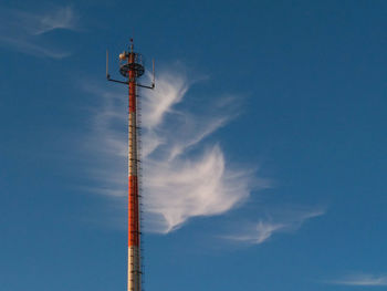 Low angle view of communications tower against sky