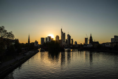 View of buildings in city at sunset