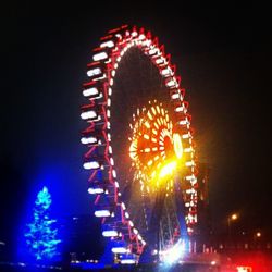 Low angle view of ferris wheel at night