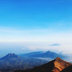 Scenic view of mountains against blue sky