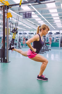 Woman exercising with resistance band at gym