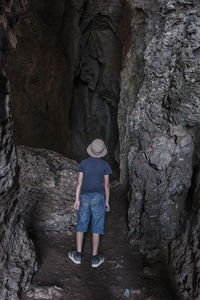 Rear view of man standing on rock