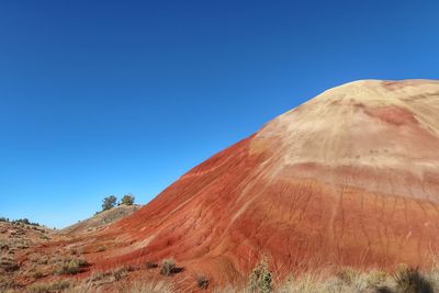 Scenic view of mountain against blue sky