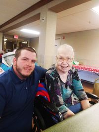 Portrait of smiling young woman sitting at home