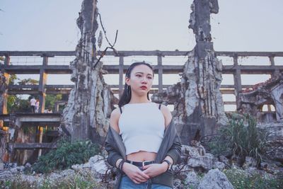 Portrait of young woman sitting outdoors