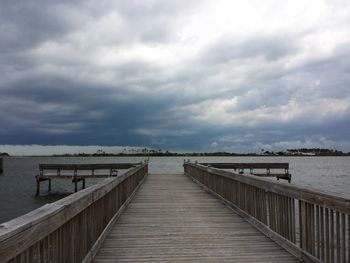 Boardwalk on beach against sky