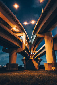 Low angle view of bridge against sky at night