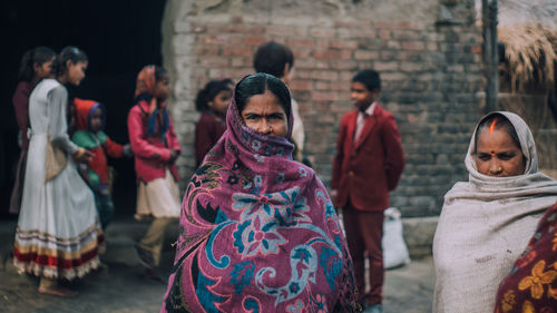 Rear view of people standing at market