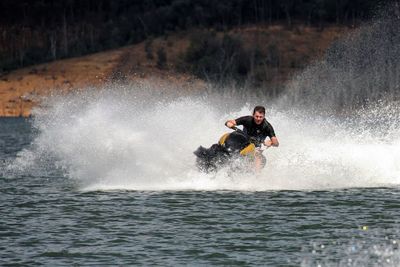 Man jet skiing in river