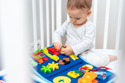 Boy playing with toy blocks on table