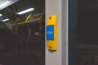 Close-up of yellow sign on door